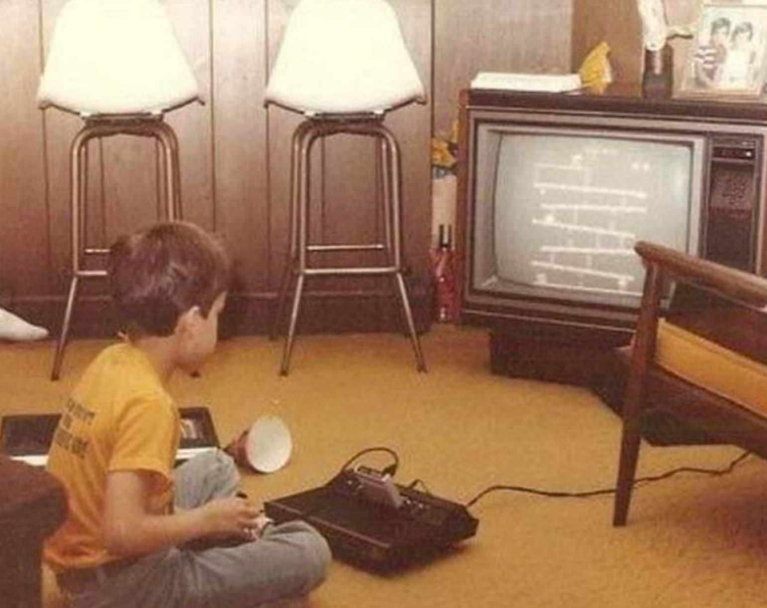 “Child playing Atari in his home 1982.”